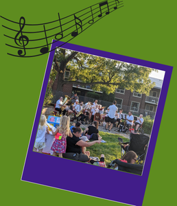 photograph of a band playing outdoors and people sitting on the grass